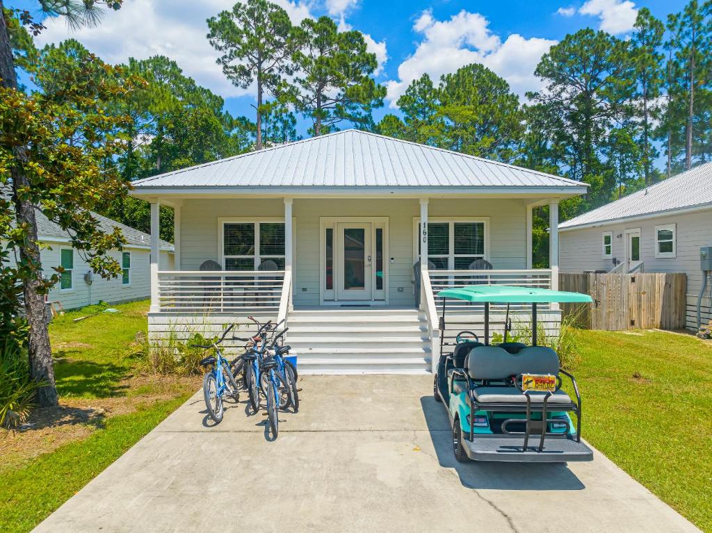 a white house with bikes parked in front of it at 30A Pet Friendly Beach House - Beach Bayou by Panhandle Getaways in Santa Rosa Beach