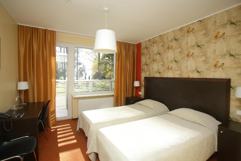 Postel nebo postele na pokoji v ubytování Pühajärve Spa & Holiday Resort