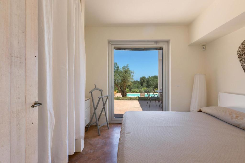 Łóżko lub łóżka w pokoju w obiekcie Villa Lisy by Perle di Puglia