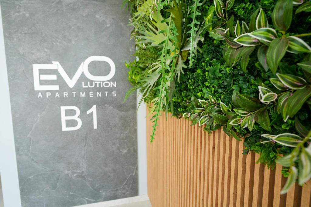 a sign that reads evo union applications bh next to plants at Hunyadi Luxury Evolution in Sibiu