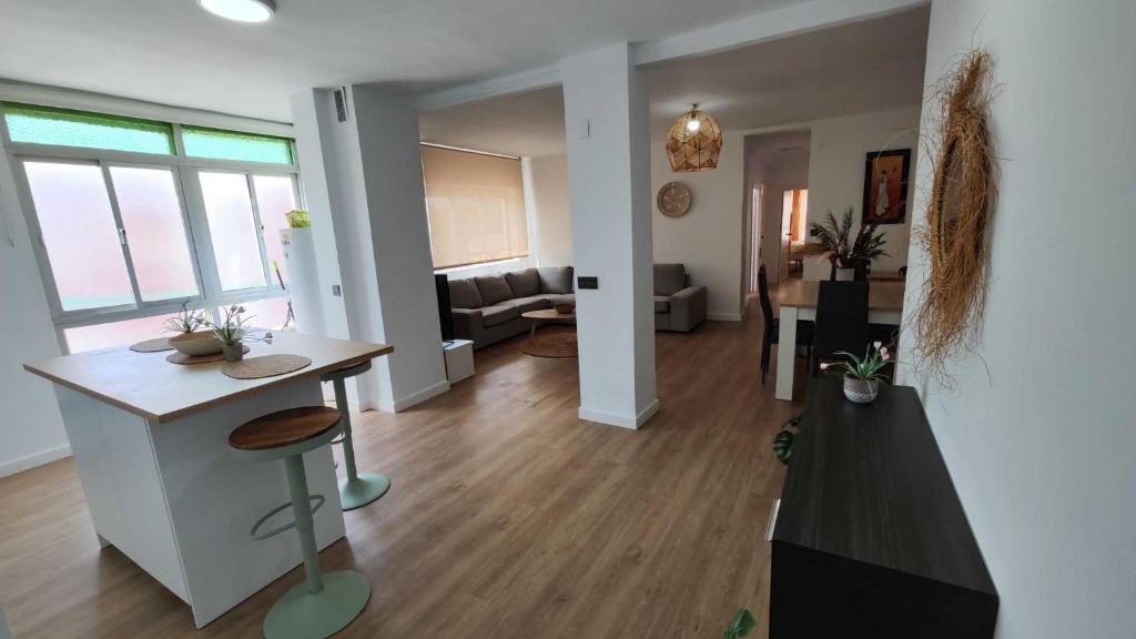 a living room with a kitchen and a living room with a table at Tarifa Ocean Side Tu espacio de descanso in Tarifa
