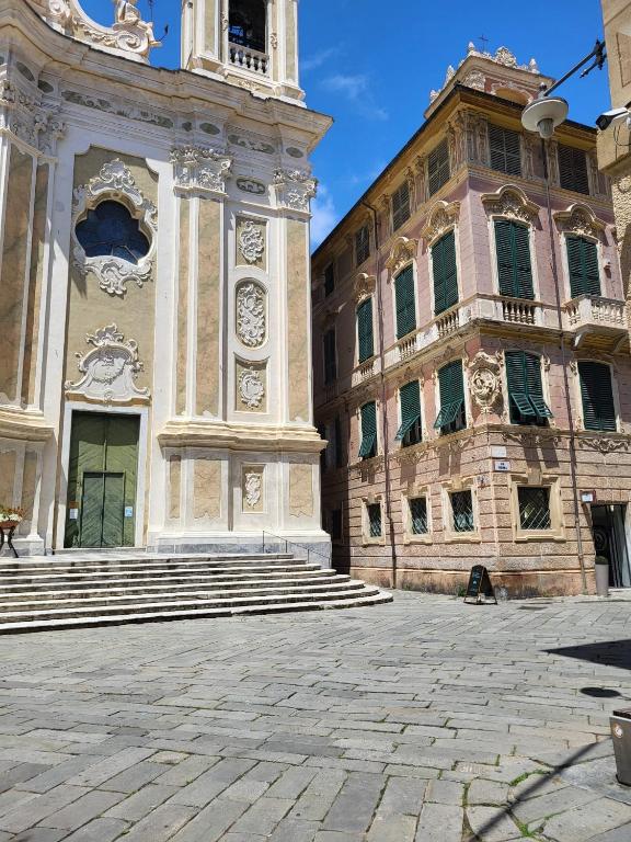 a building with a clock tower in a courtyard at La Casetta in Finale Ligure