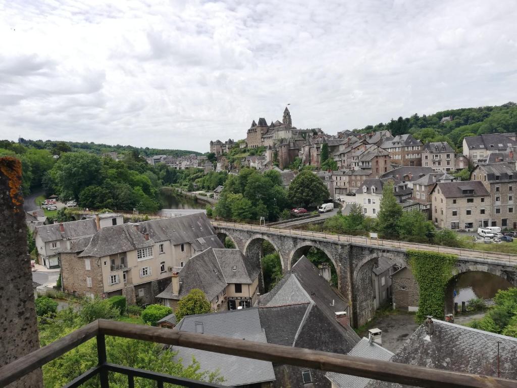 une vue d'une ville avec un vieux pont dans l'établissement Les oiseaux de passage, à Uzerche
