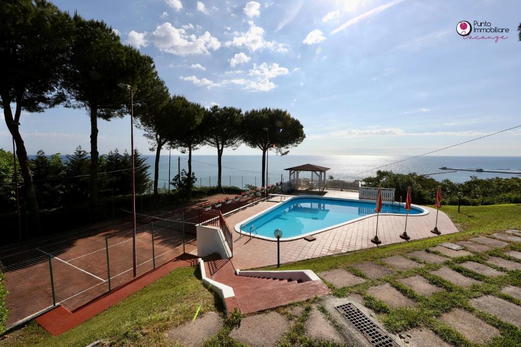 a swimming pool with a view of the ocean at Villa Nella - WelcHome in Marina di San Vito