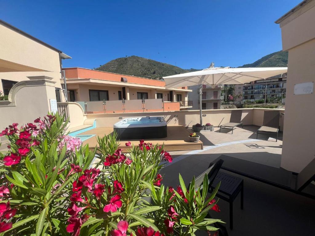 a view of a house with flowers and an umbrella at Artemis Hotel in Cefalù