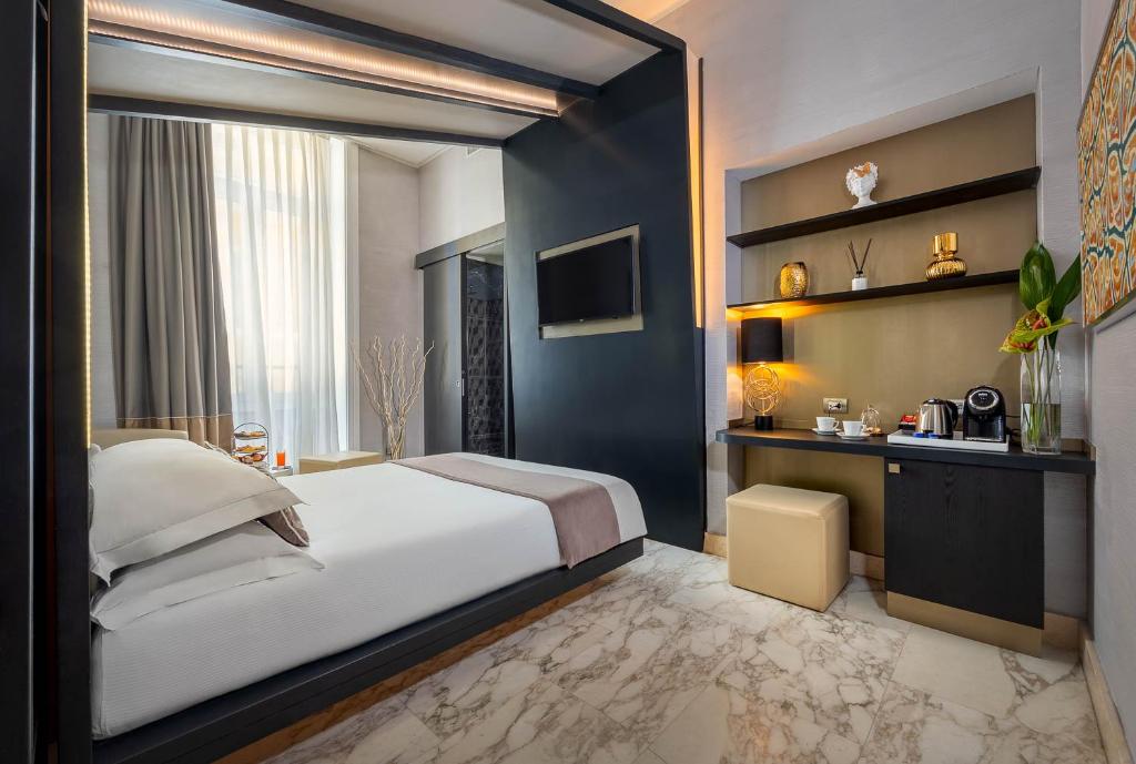 A bed or beds in a room at Dharma Luxury Hotel