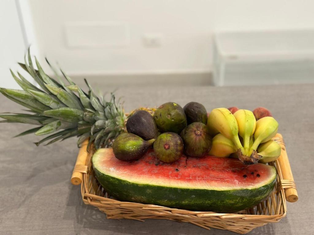 a basket filled with a bunch of bananas and fruit at Bari Lory’s Home in Bari