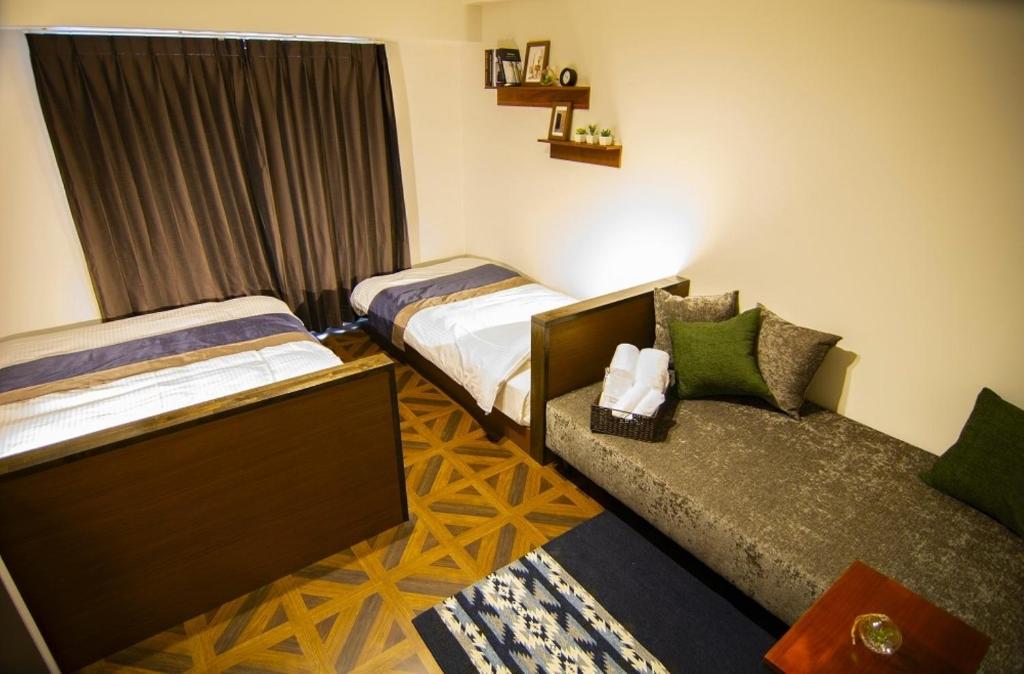Postel nebo postele na pokoji v ubytování e-stay ebisu