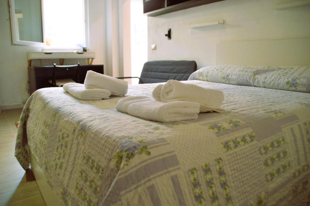a bedroom with two beds with towels on them at antignano mare in Livorno