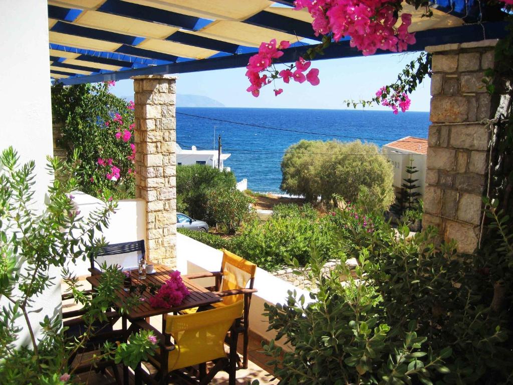 a patio with a view of the ocean at Fyri Ammos Residences in Agia Pelagia
