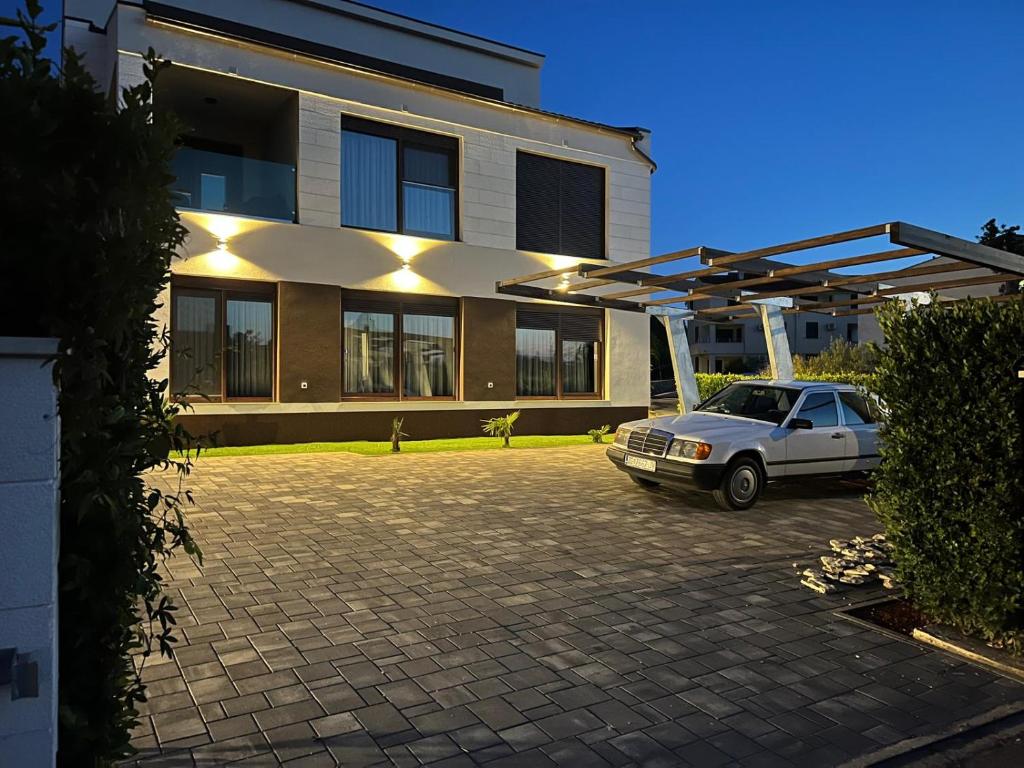 a car parked in a parking lot in front of a building at Residence 4U in Malinska