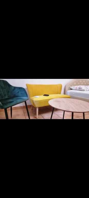 a room with two chairs and a table and a bed at Grika apartment in Split