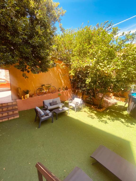 a backyard with a couch and tables and trees at CASA LAS HERRERA in Casavieja