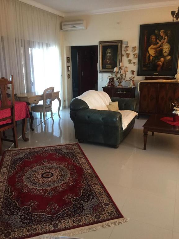 a living room with a couch and a table at Il TRAMONDO in Néa Thésis