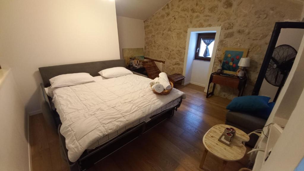 a bedroom with a large bed and a table at La casetta di Sofi in Petralia Soprana