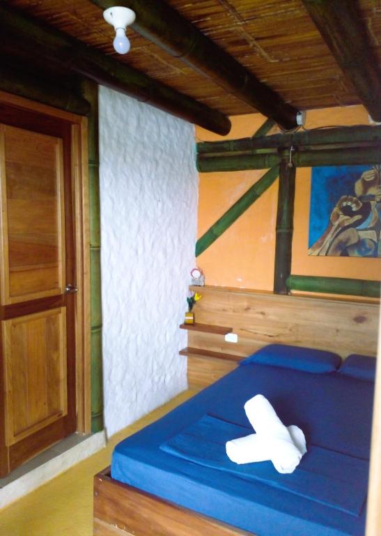 Postel nebo postele na pokoji v ubytování Hostal Yemayá Mompiche