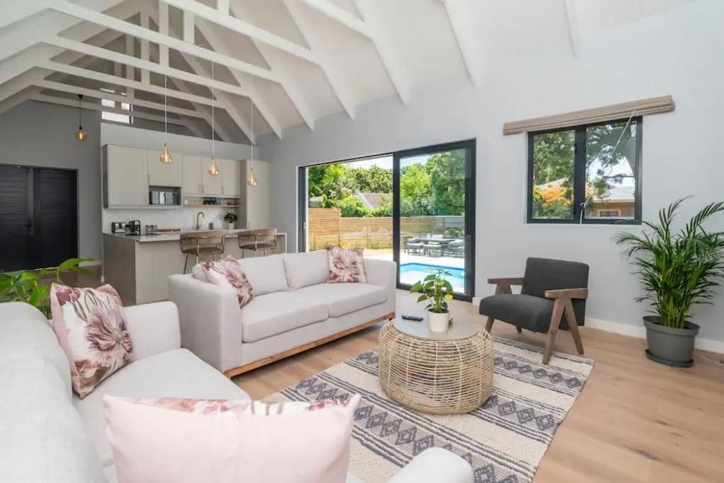 a living room with a couch and a table at Stunning House in Constantia in Cape Town