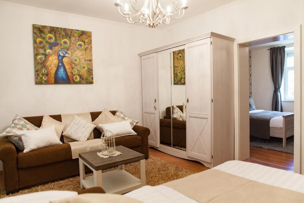 a living room with a couch and a bedroom at Apartments Artorius Laško in Laško