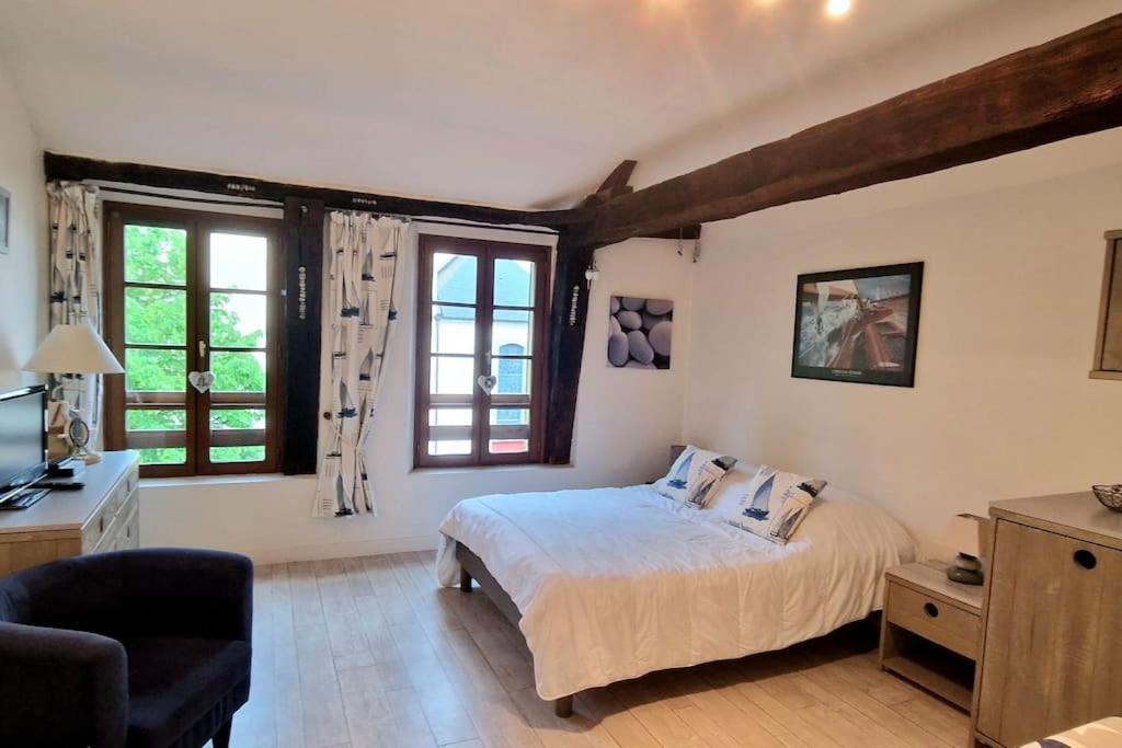 une chambre avec un lit et deux fenêtres dans l'établissement Studio centre historique Vannes, à Vannes