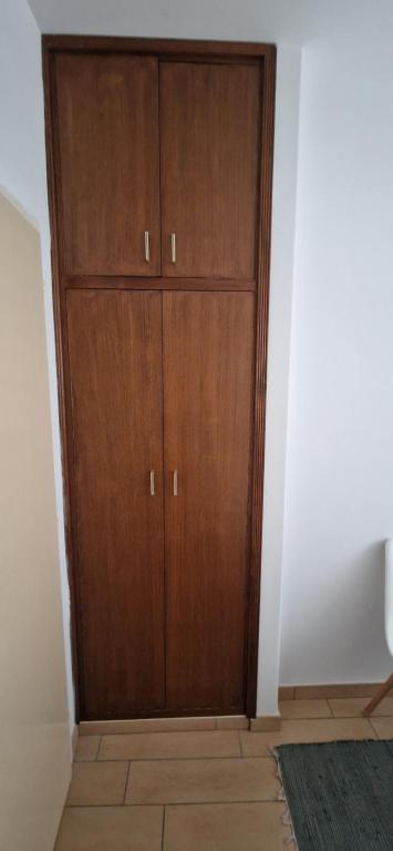 a large wooden cabinet in a corner of a room at Palute in Supetar