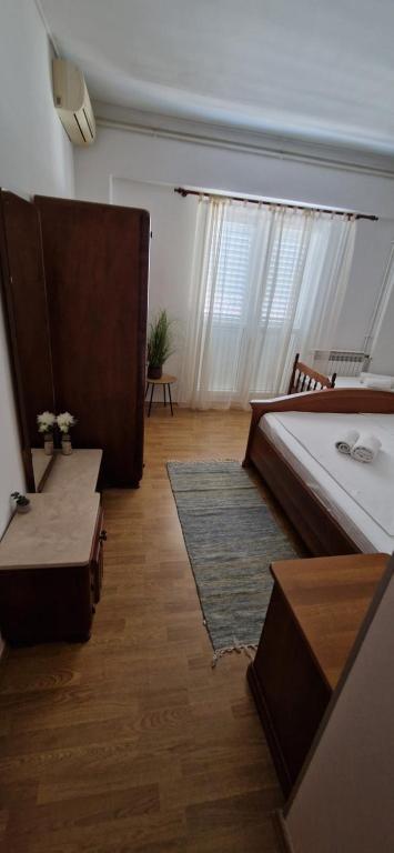 a bedroom with a bed and a table and a rug at Palute in Supetar