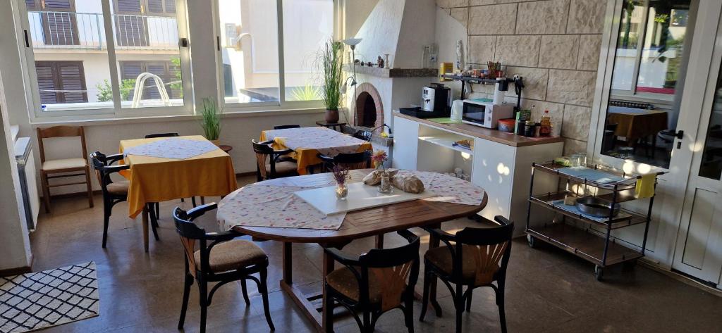 a room with a table and chairs and a kitchen at Palute in Supetar