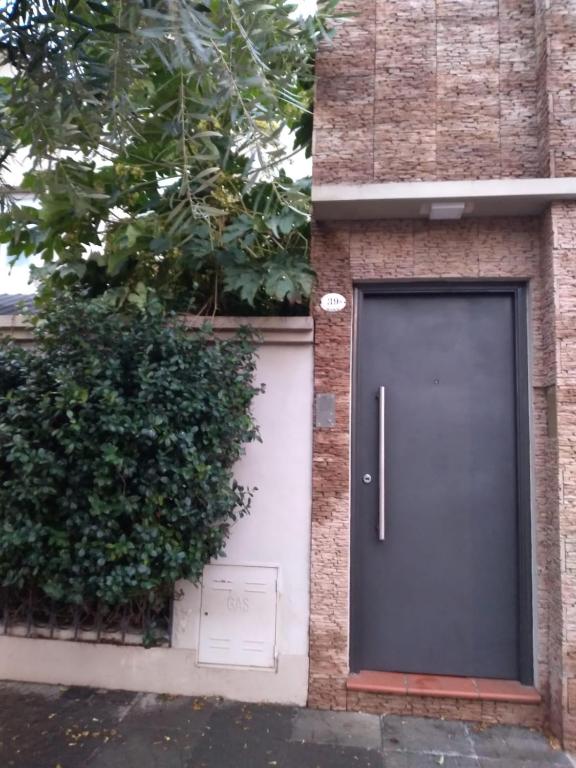 a door on the side of a brick building at El Olivo in Gualeguaychú