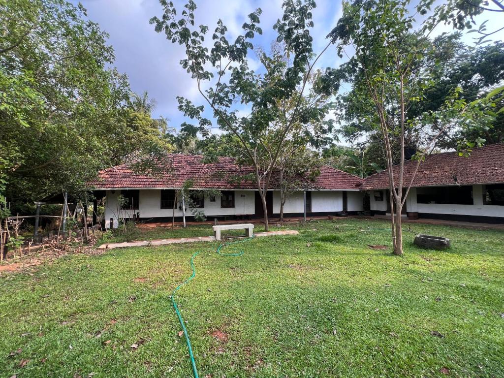 a house with a yard with a hose at Svarna in Udupi
