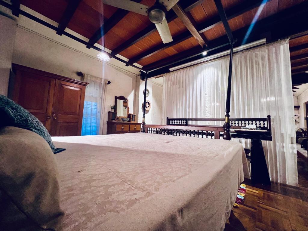 a bedroom with a large bed in a room at Svarna in Udupi