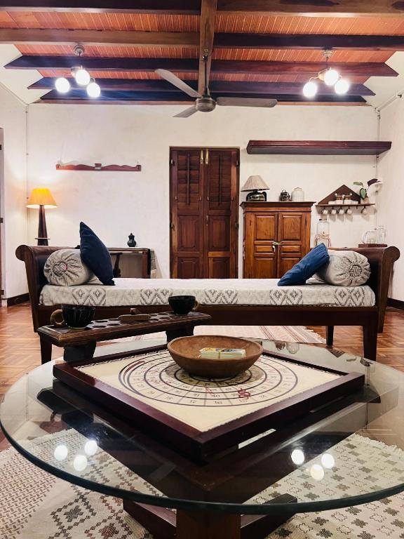 a living room with a couch and a table at Svarna in Udupi