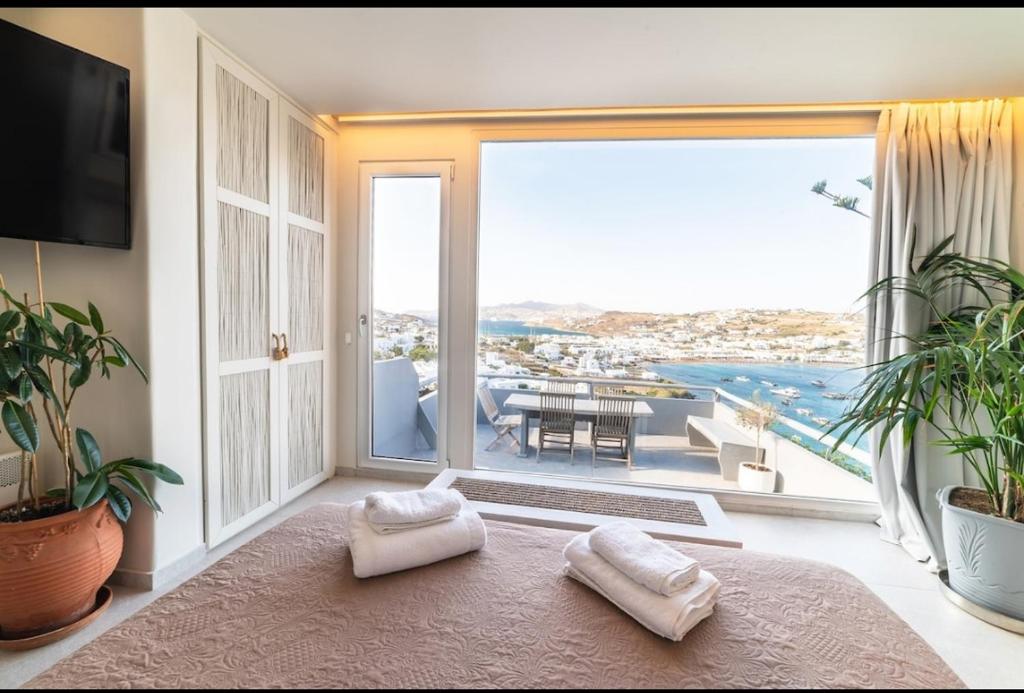 a living room with a large window with a view at Villa il Sole di Juljan in Mikonos