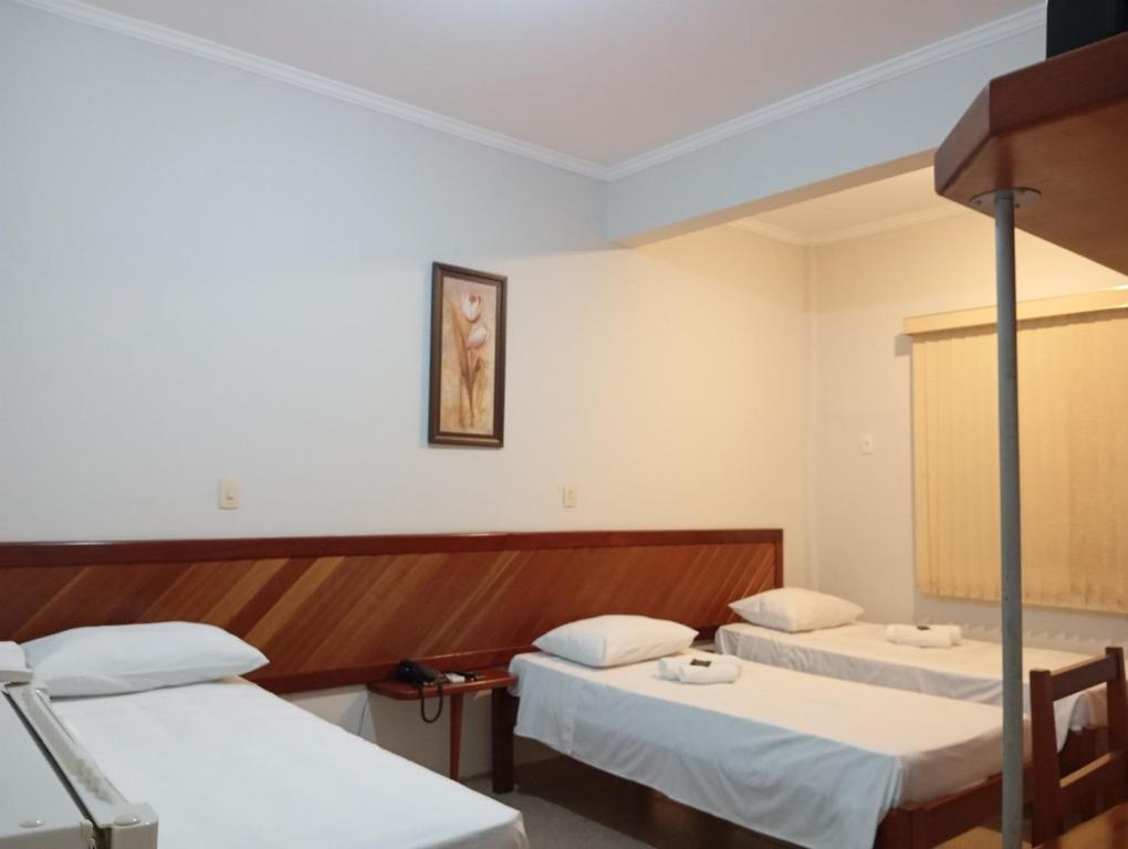 Postel nebo postele na pokoji v ubytování Mariachis Hotel