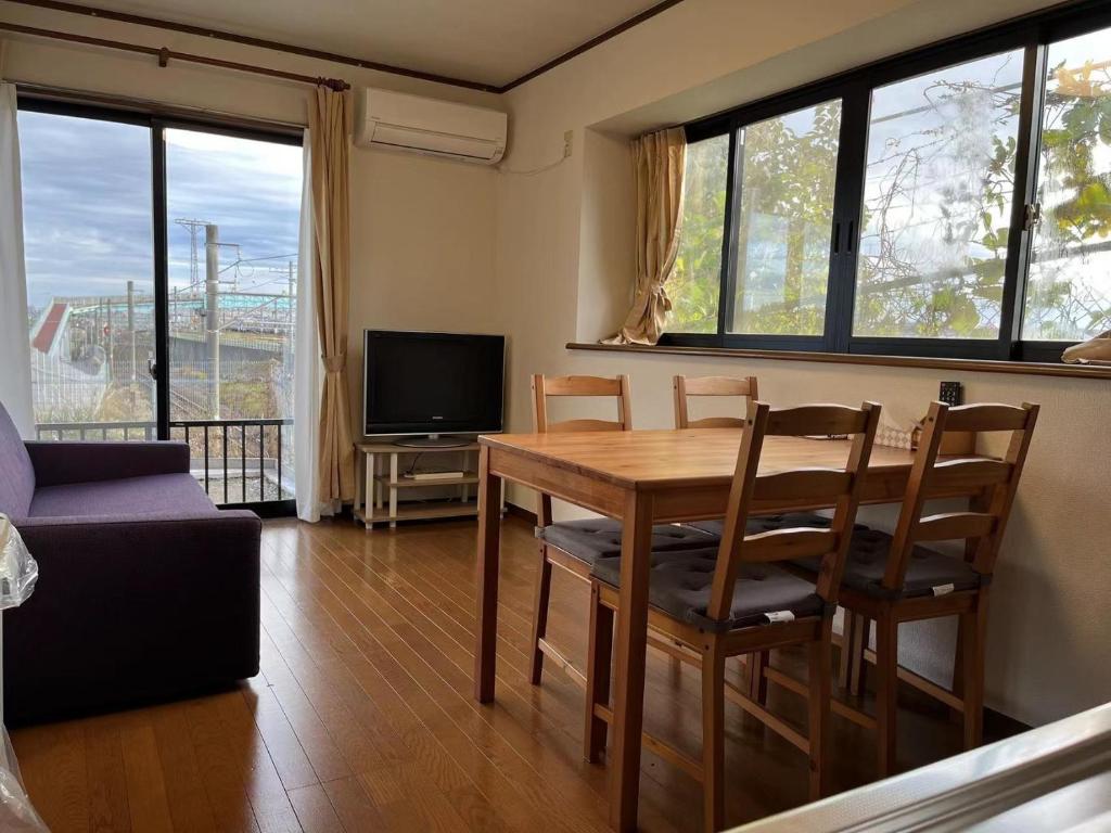 a living room with a table and chairs and a television at Rakuten Stay [Homelike Makuhari Hongo] - Vacation STAY 16003v in Chiba