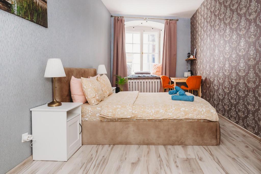 a bedroom with a bed with a teddy bear on it at Old Town Private Room, Shared Bath - D in Tallinn