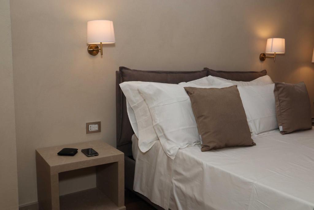 Postel nebo postele na pokoji v ubytování Quarto di Monte Suite & Spa