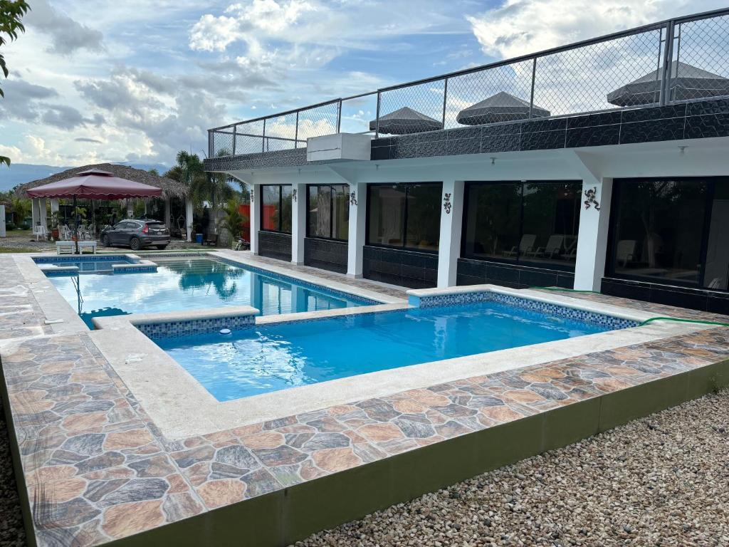 a swimming pool in front of a house at Casa de Campo Nerys in SJM