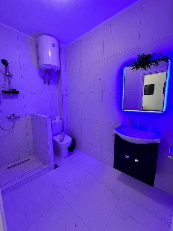 a bathroom with a toilet and a sink and a mirror at SUNRISE SEA VIEW SUITE by Eden in Paralia Katerinis
