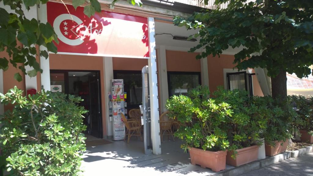 a restaurant with plants in front of it at Hotel Canasta in Rimini