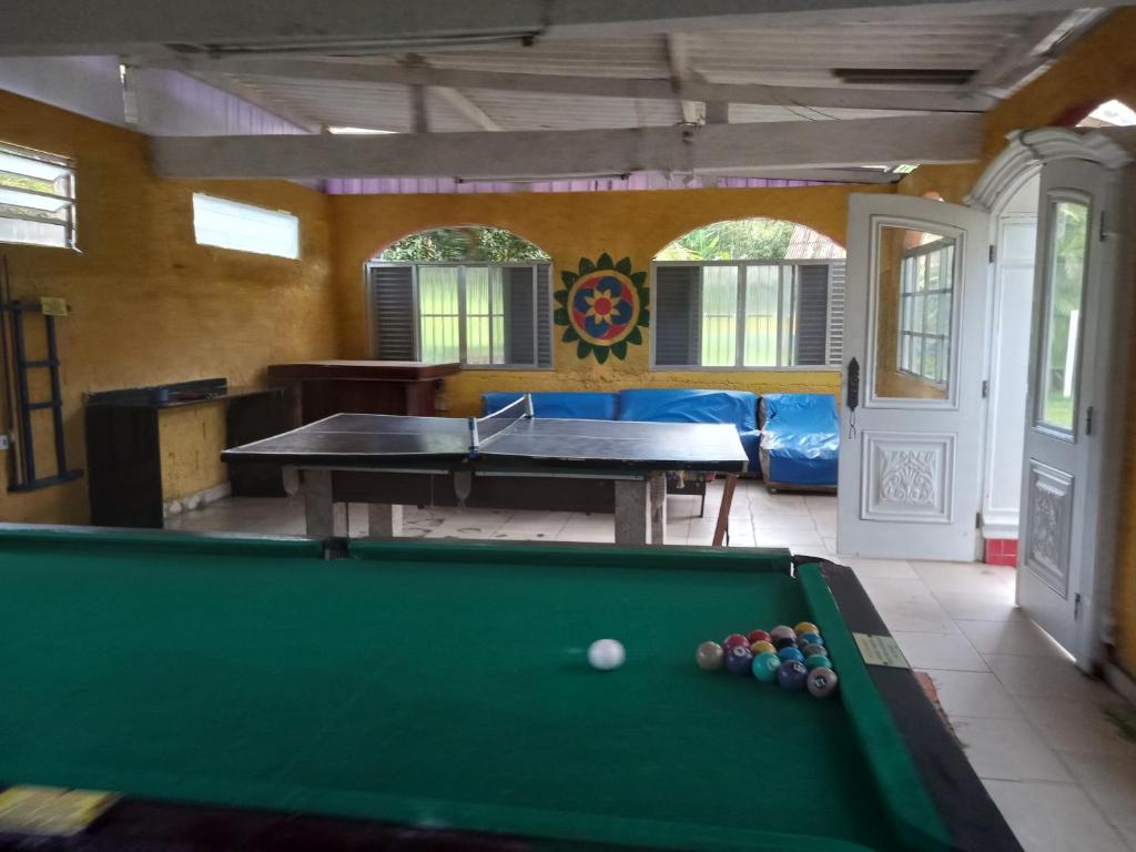 a billiard room with a pool table in it at Casa temporada cachoeira in São Vicente