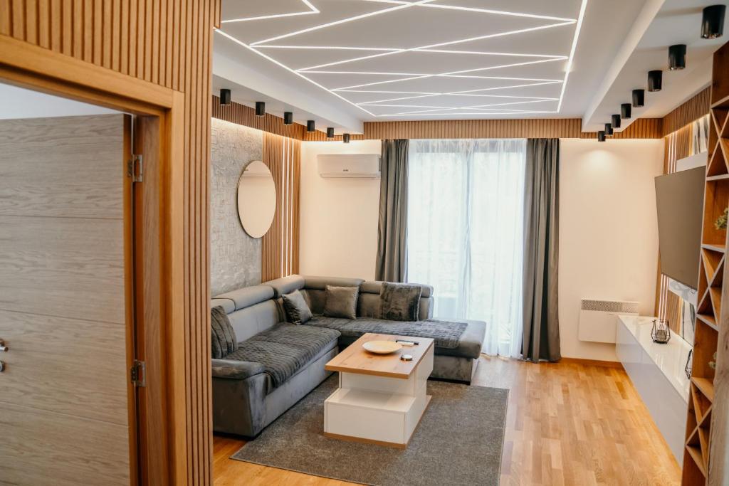 a living room with a couch and a table at Pine Lux Zlatibor in Zlatibor