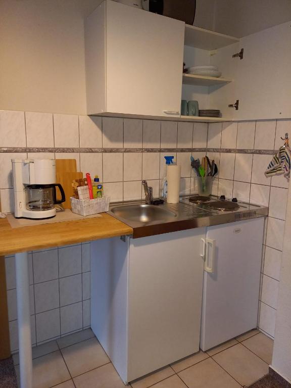 a kitchen with a sink and a counter top at Ferienwohnung Hofapartment in Milkersdorf