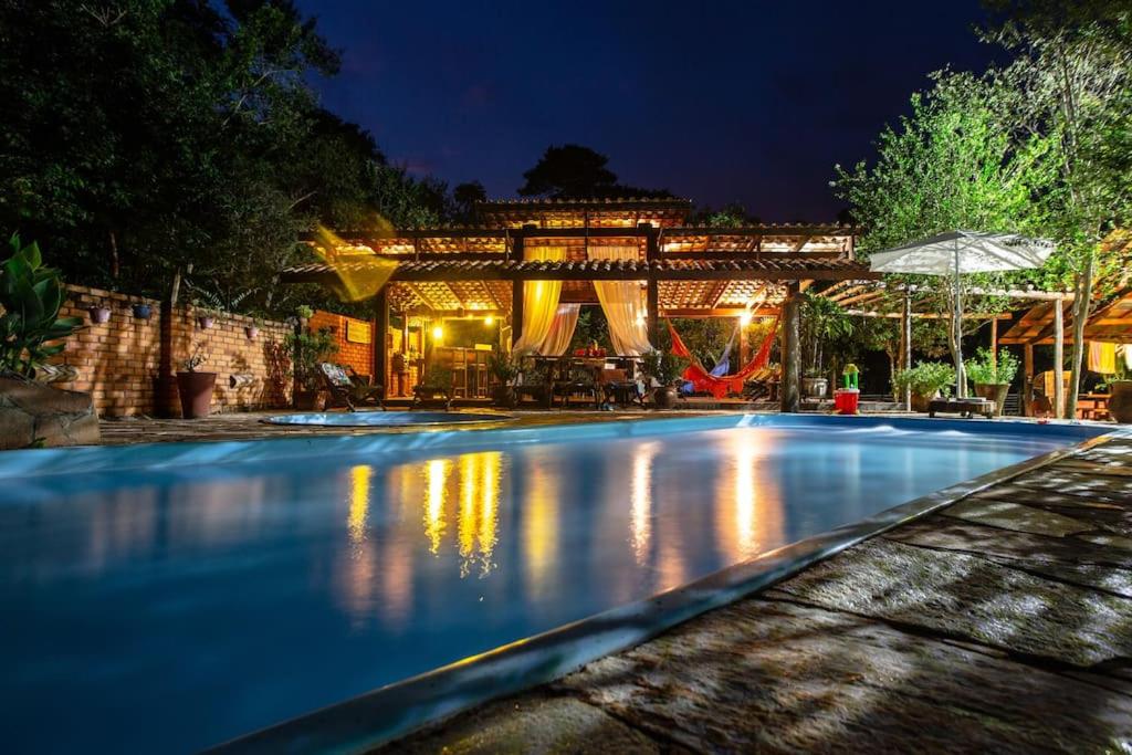 uma grande piscina à noite com um edifício em Fazenda Lagoinha em Chapada dos Guimarães