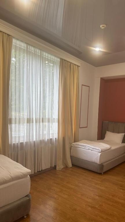 Postel nebo postele na pokoji v ubytování Wald Hotel Lagodekhi