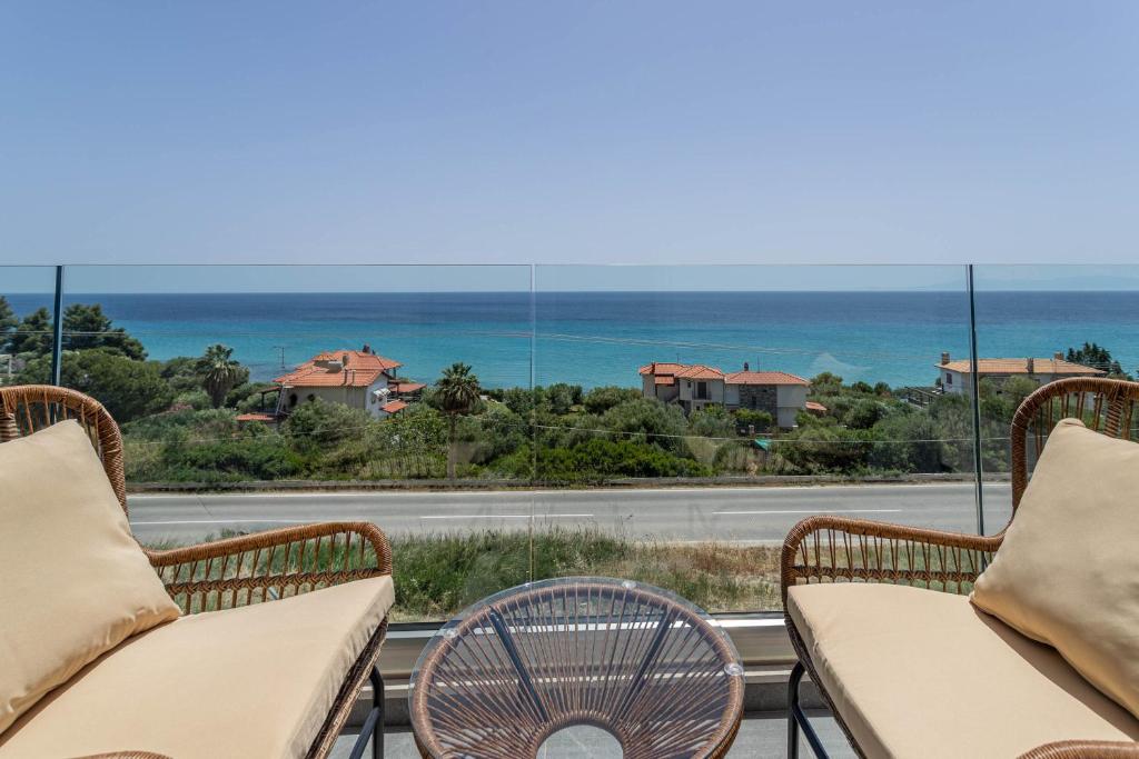 a balcony with chairs and a view of the ocean at Alexmare SeaView House Mola Kaliva in Mola Kalyva