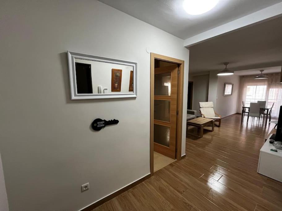 a living room with a television on a wall at Apartamento en Isla Cristina in Isla Cristina