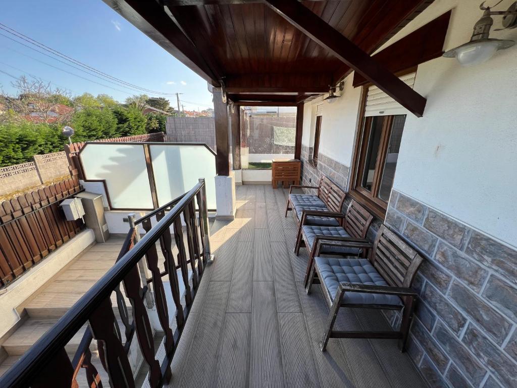 a balcony with benches on a building at Casita independiente Casa Corban in Santander