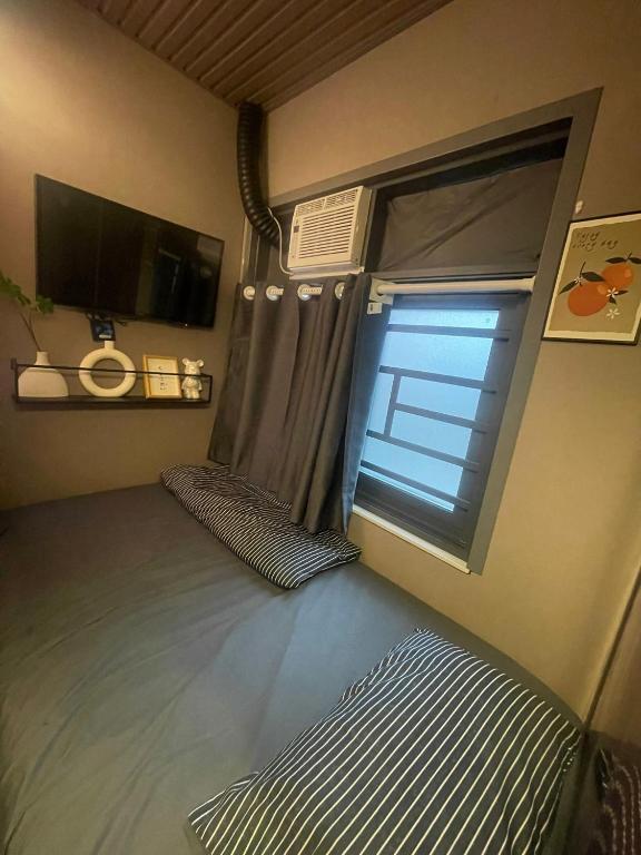 Postel nebo postele na pokoji v ubytování 榆迪賓館 YUTIK Guesthouse
