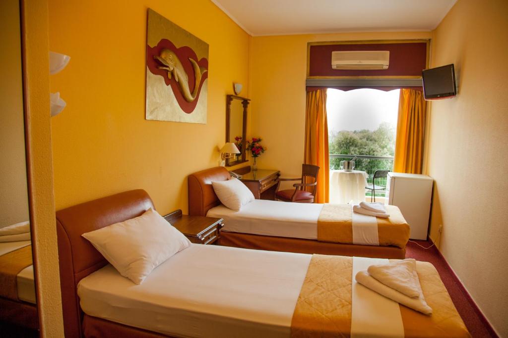 Ένα ή περισσότερα κρεβάτια σε δωμάτιο στο Galini Palace