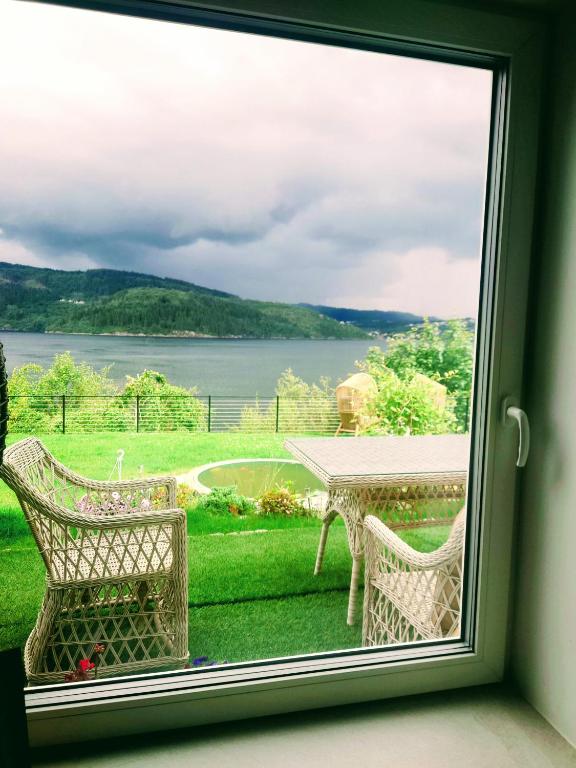 a window with a view of a table and chairs at Bergen sunrise Apartment - self check in - Free Parking in Bergen