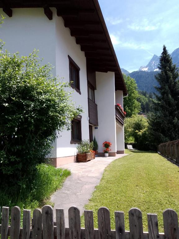 a house with a fence in front of a yard at Ferienhaus Heimatplatzle in Oetz